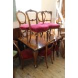 A late Victorian extending mahogany dining table with ten assorted chairs