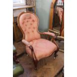 A mid Victorian walnut button back armchair
