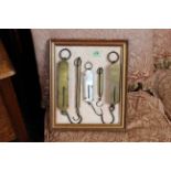 A selection of vintage scales in decorative frame
