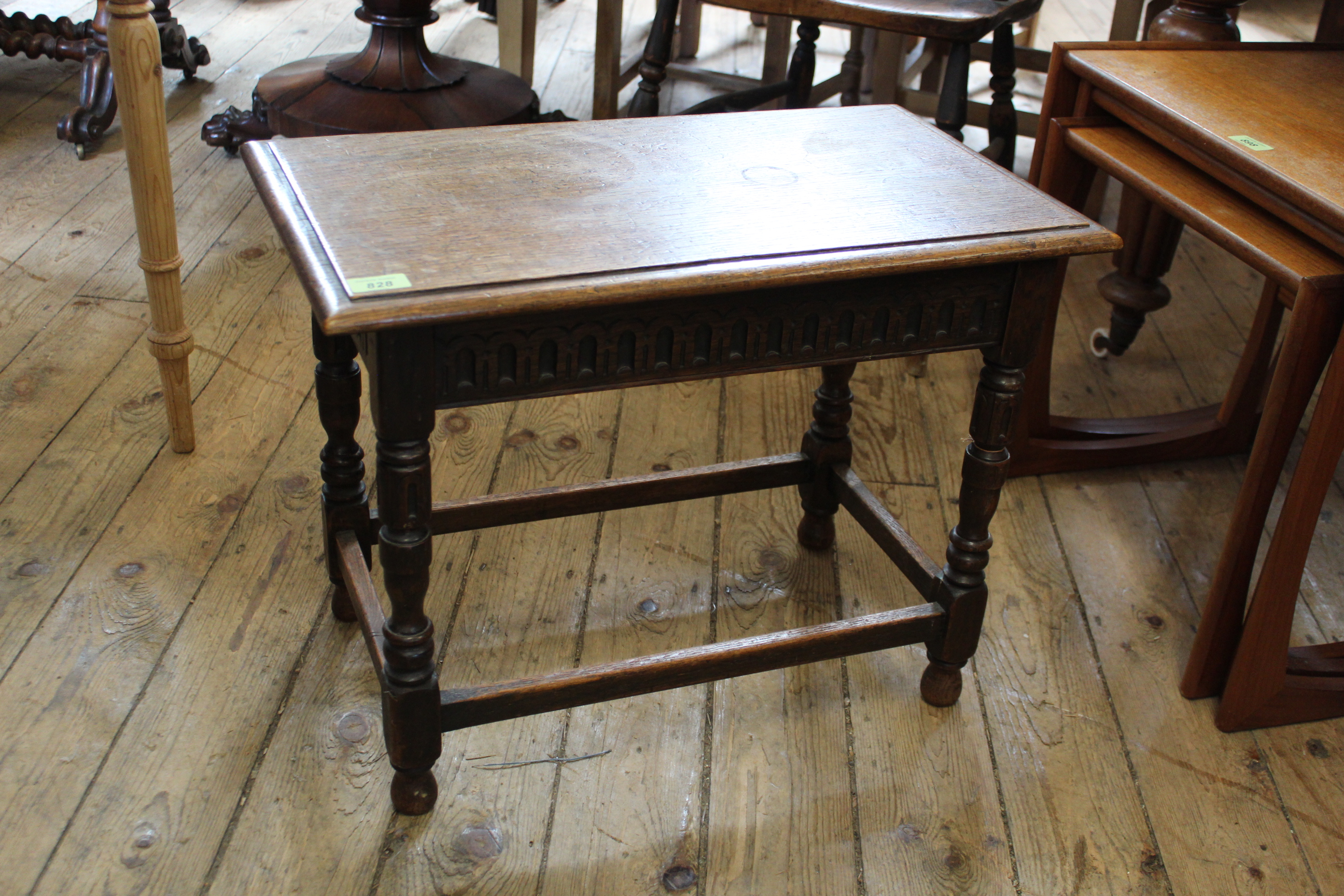 A carved oak stretcher table