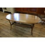An Ercol elm coffee table with glass shelved undertier