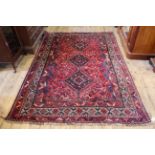 A wool red and blue ground rug,