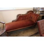 A mid Victorian carved stained pine upholstered chaise longue