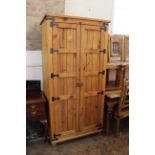 A modern stained pine two door cupboard