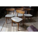 A set of four upholstered beech and teak mid Century dining chairs