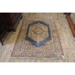 A cream and multi coloured silk rug,