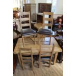 A modern oak extending dining table with six chairs