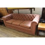 An upholstered three seater Chesterfield style button back sofa