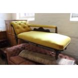 An early 20th Century carved oak upholstered chaise longue