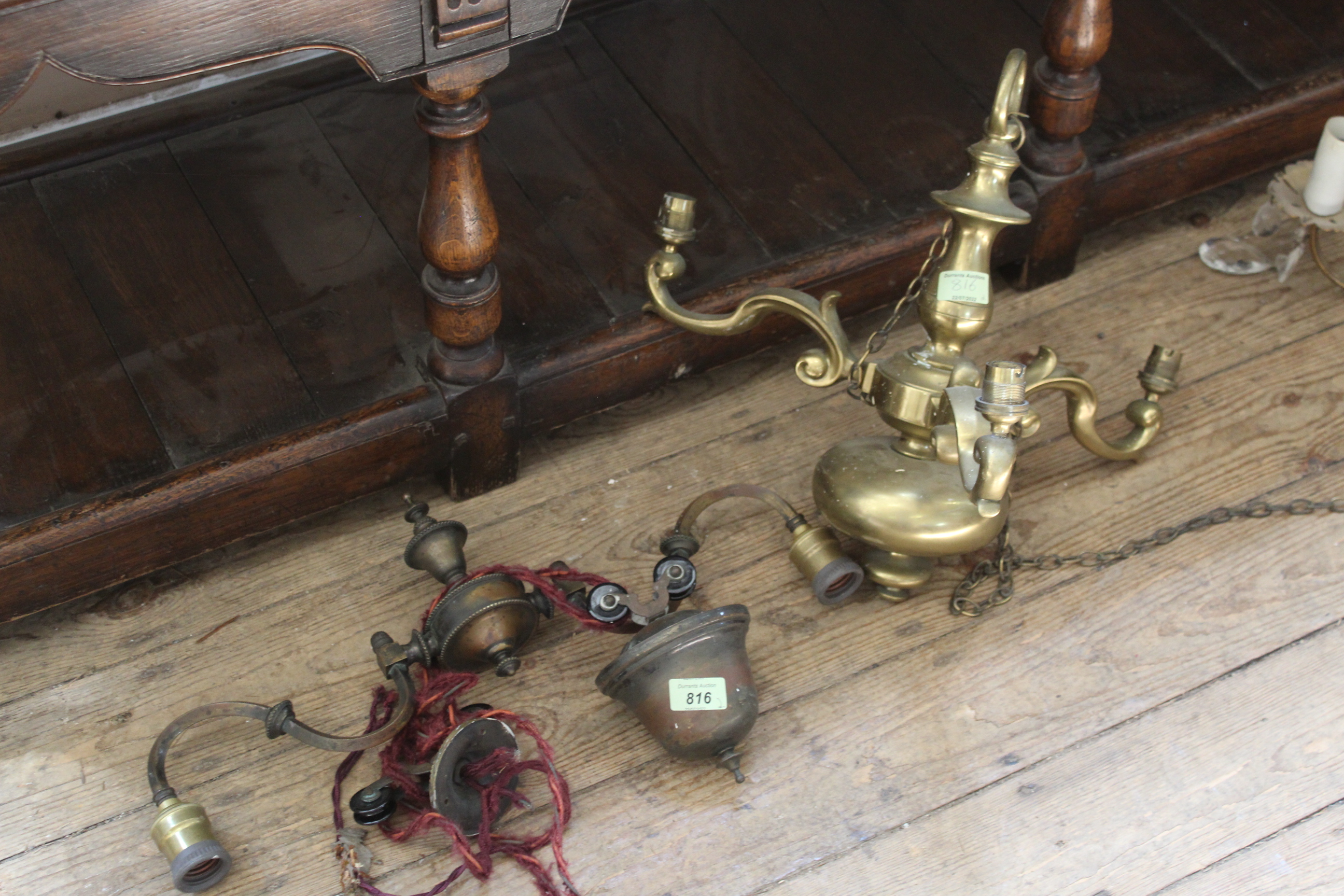 Two brass light fixtures including a roped pull light
