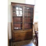 An early 19th Century mahogany bookcase married with a late 19th Century base with single drawer