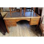A c1930's oak five drawer desk