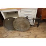 A Middle Eastern folding brass table together with a hanging brass dish