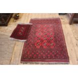 A red ground handmade rug together with a prayer rug,