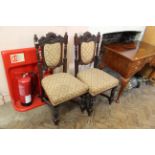 A pair of late 19th Century carved mahogany chairs