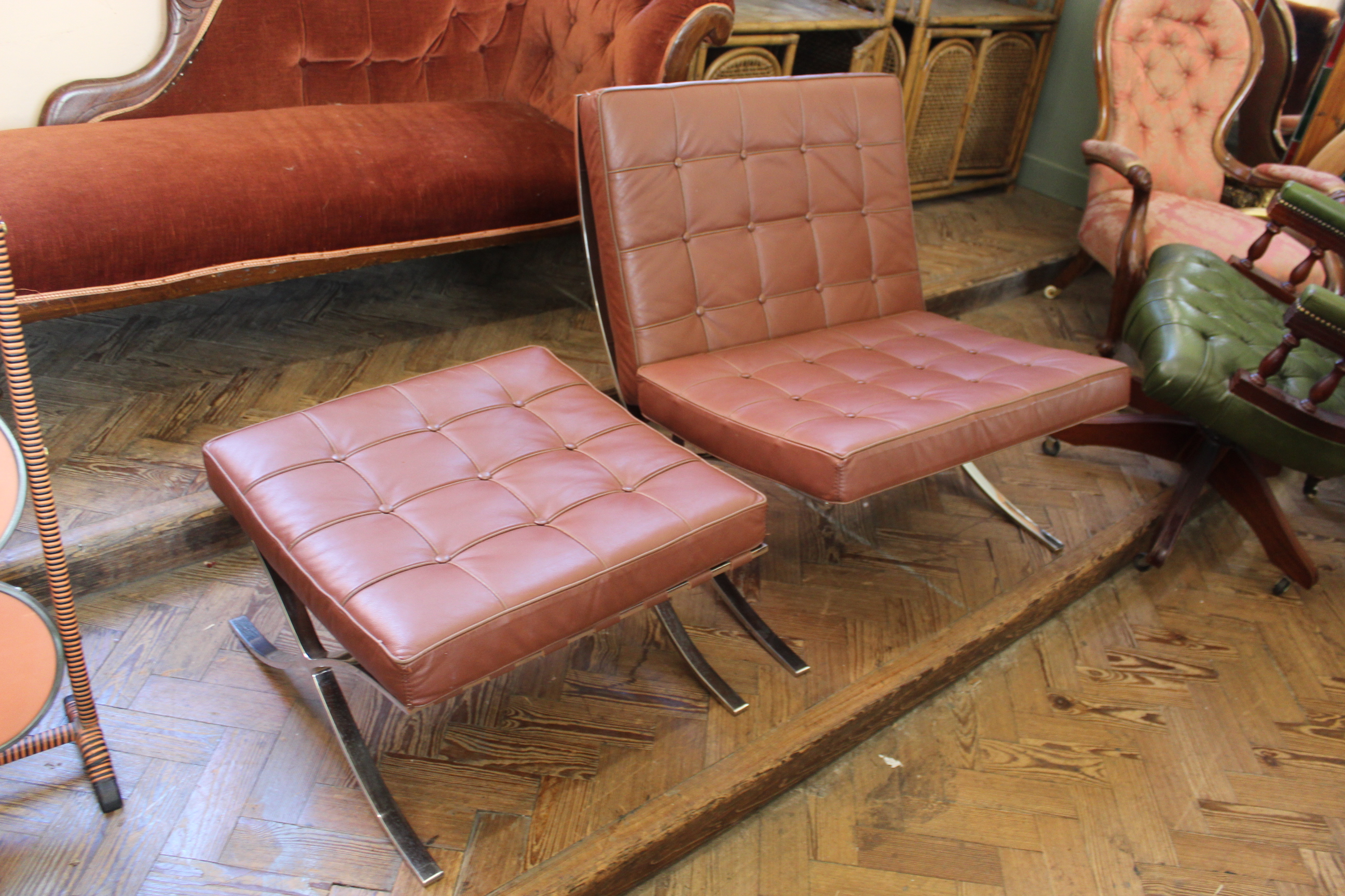 A Barcelona style leather and chrome lounge chair and matching stool