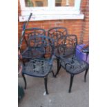 A set of four black metal garden chairs