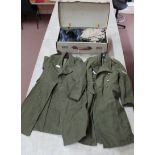 A vintage suitcase containing various military clothing etc with two post war great coats