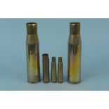 A pair of 37mm brass shell cases with WWII dated 20mm and two 50 cal cases,