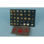 A carded display of various Norfolk Regiment buttons with a WWI era armband marked D.Co 4th N.V.R.