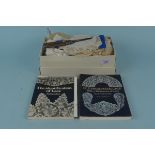 A small box of old lace in various styles and sizes plus two books on identifying old lace