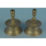 Two antique capstan style brass candlesticks, 13.5cm and 12.