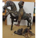A large antique Oriental carved wooden figure of a female astride a horse,