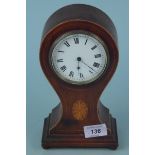 An Edwardian inlaid mahogany balloon clock in the Sheraton style