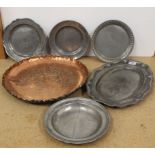 A large decorated copper tray, 40cm diameter plus five items of vintage pewter plates,