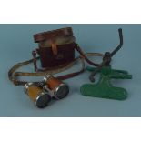 A vintage metal garden sprinkler plus a cased pair of opera glasses