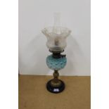 A Victorian brass oil lamp with a turquoise glass reservoir and etched shade (converted)