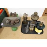 A set of 1920's grocery scales with a copper pan and assorted weights plus four oil lamps