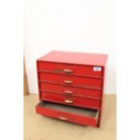 A vintage five drawer table top stationary chest
