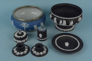 Six pieces of Wedgwood black Jasperware including a fruit bowl and candlesticks plus a Wedgwood