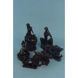 Two resin figurines of ladies plus a coiled snake and three dragon figures