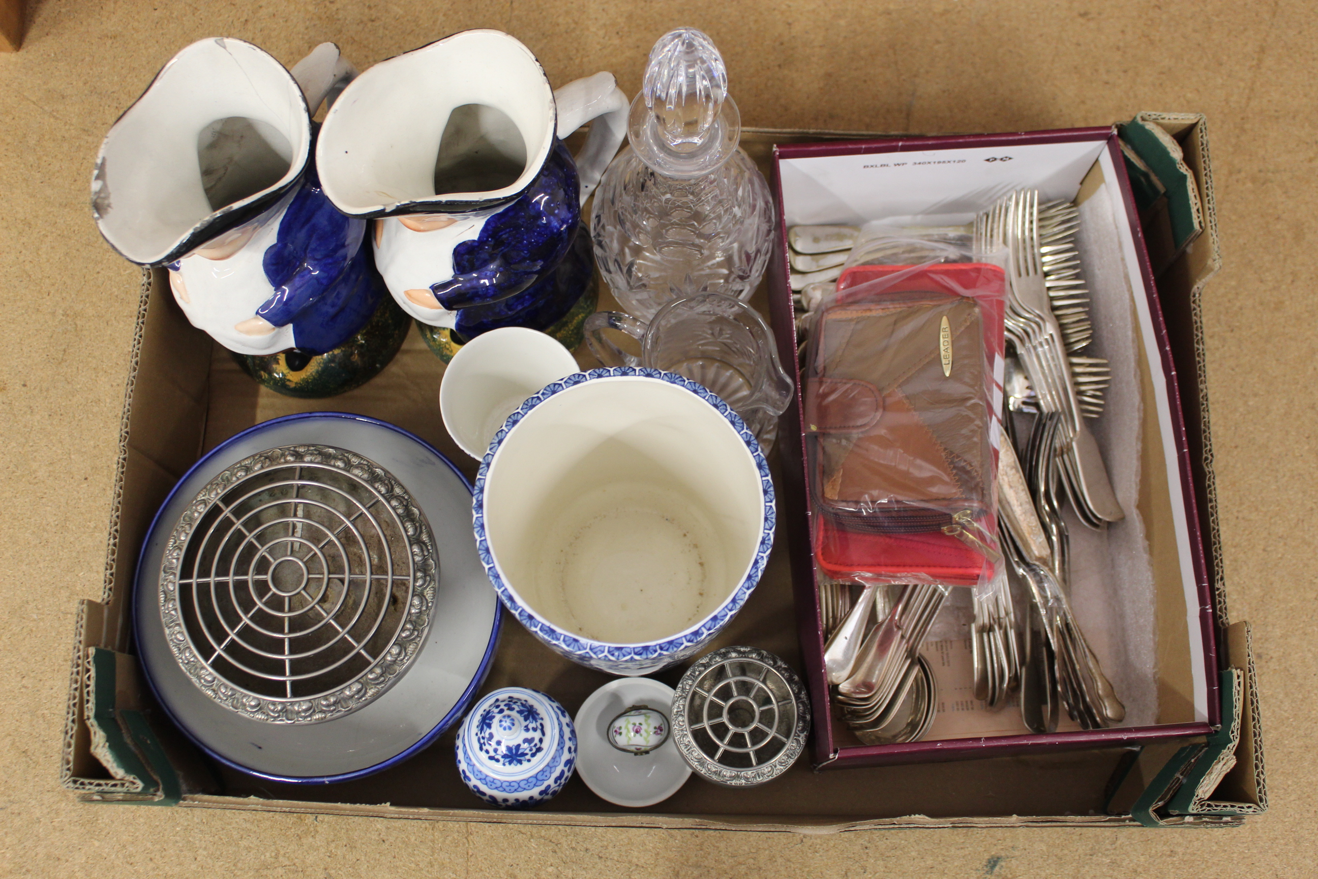 A mixed box of items including a pair of Staffordshire Toby jugs, blue and white china,