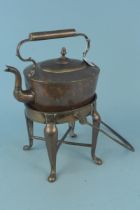 An antique seamed copper kettle together with its swing handle fireside stand