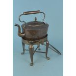 An antique seamed copper kettle together with its swing handle fireside stand