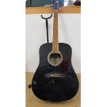 An Encore acoustic guitar with stand