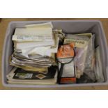 A box of loose stamps mounted on pages and multiple world in envelopes,