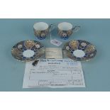 A pair of Japanese Fukagawa porcelain cups and saucers