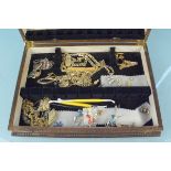 A wooden cutlery box with contents of costume jewellery