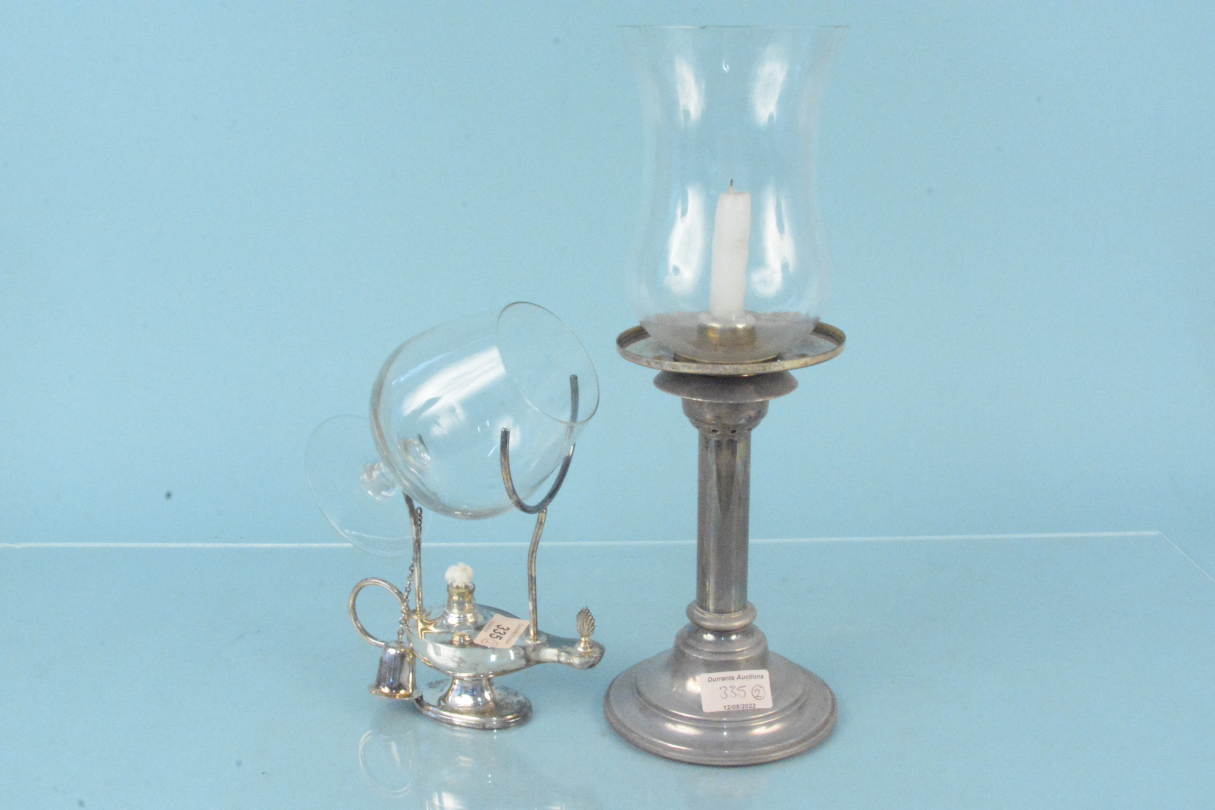 A silver plated brandy warmer in the form of Aladdins lamp plus a white metal lamp with glass