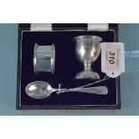 A cased egg cup napkin ring and spoon set,