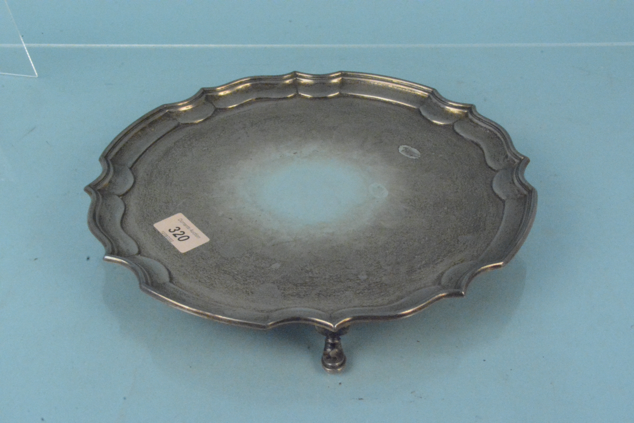 A circular silver salver on three pad feet, hallmarked Sheffield 1945, maker William Bush & Son Ltd, - Image 2 of 3