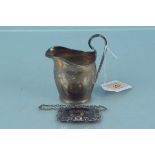A small silver cream jug and a silver Scotch label, cream jug hallmarked Chester 1912,