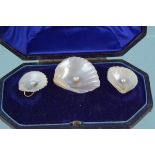 An unusual brooch and earrings set comprising of pearl set natural shell shapes with yellow metal