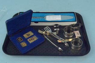 A collection of silver and silver plated items including a silver gilt stamp set, napkin rings,