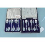 Two sets of six silver teaspoons, both cased and one with golf decoration,