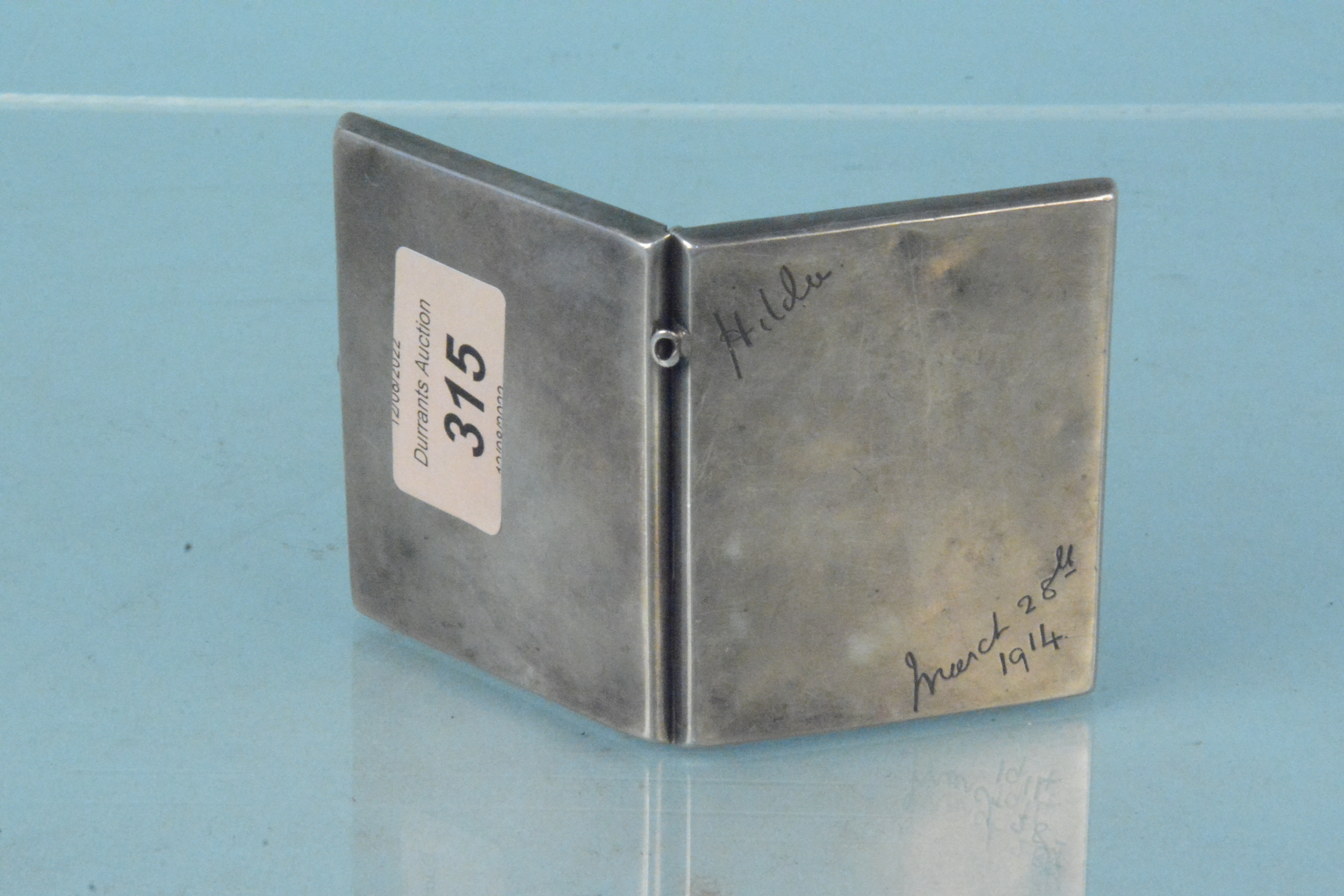 A silver cigarette case with inscription to front, hallmarked Birmingham 1912,